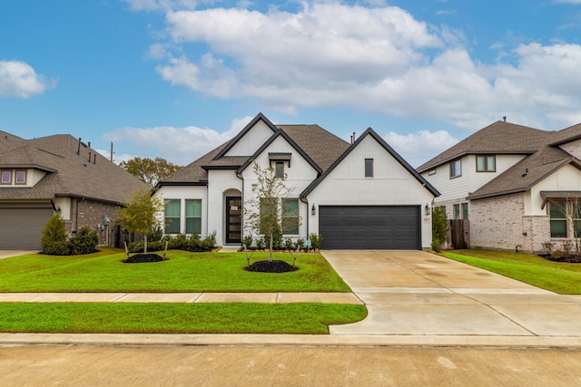 french country inspired facade featuring a garage and a front yard