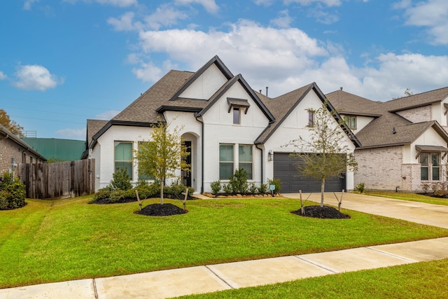 french country style house with a garage and a front yard