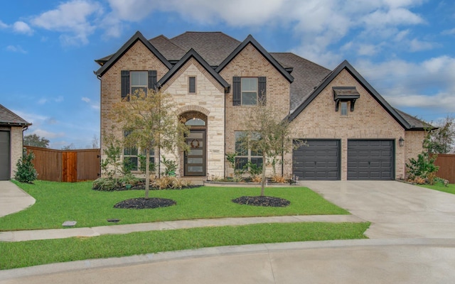 view of front of home with a garage and a front lawn