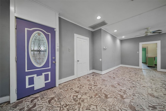 entryway with ornamental molding and ceiling fan