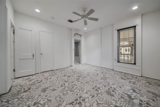 unfurnished bedroom with ceiling fan and light colored carpet