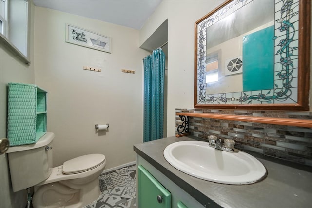 bathroom featuring tile patterned flooring, vanity, and toilet