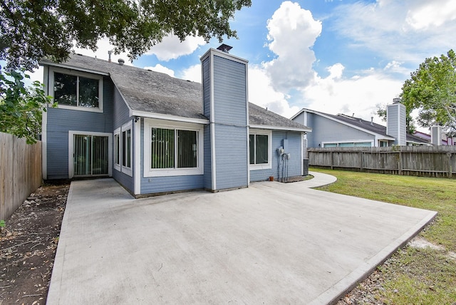 back of house featuring a yard and a patio area