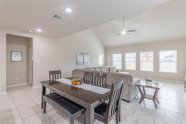 dining area with lofted ceiling, ceiling fan, and light tile patterned flooring