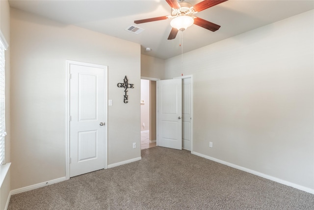 empty room with ceiling fan and carpet flooring