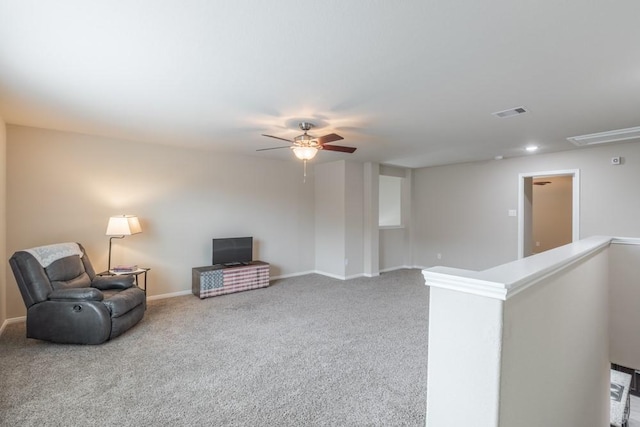 living area with ceiling fan and carpet floors