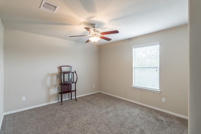 carpeted empty room featuring ceiling fan