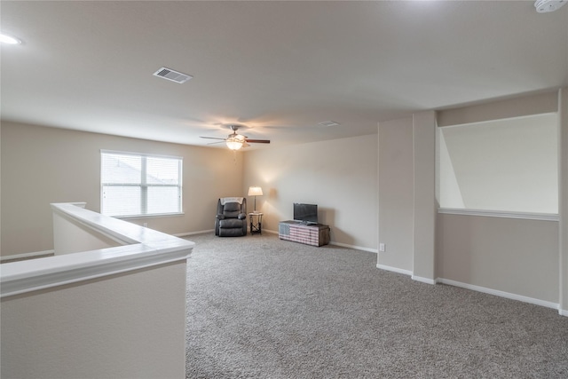 interior space featuring carpet and ceiling fan