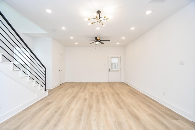 unfurnished living room featuring ceiling fan and light wood-type flooring