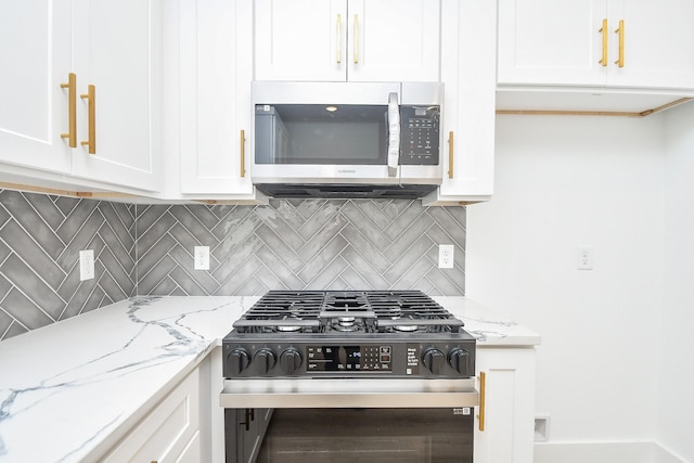 kitchen with white cabinetry, decorative backsplash, black range with gas stovetop, and light stone counters