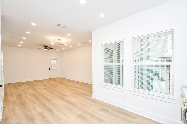 empty room featuring ceiling fan and light hardwood / wood-style flooring