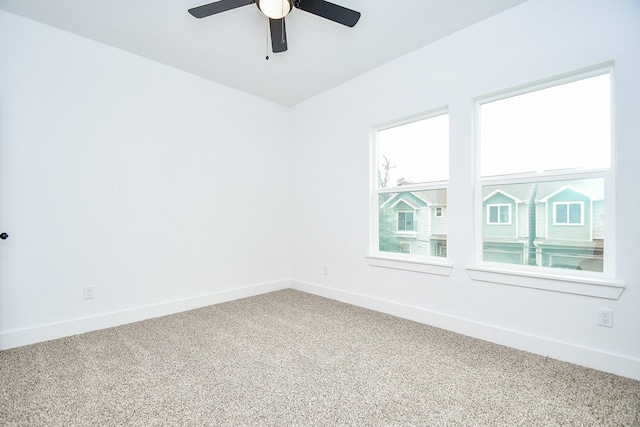 spare room featuring ceiling fan and carpet floors