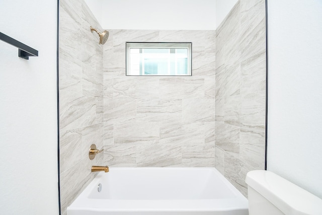 bathroom featuring toilet and tiled shower / bath combo