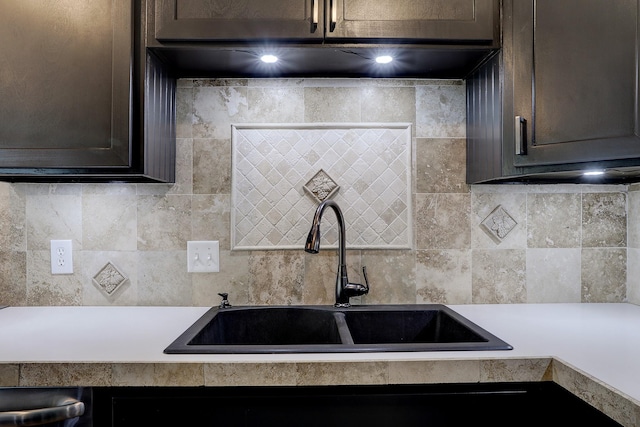 kitchen with sink, decorative backsplash, and dark brown cabinets