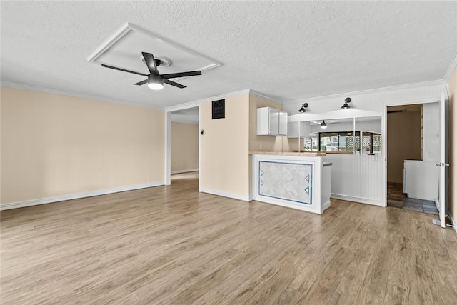 unfurnished living room featuring crown molding, ceiling fan, light hardwood / wood-style flooring, and a textured ceiling