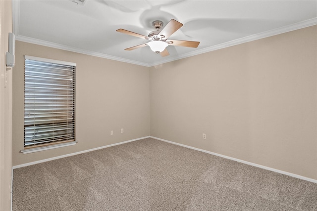 carpeted spare room with ceiling fan and ornamental molding