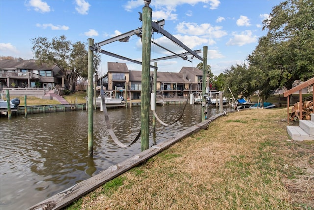 view of dock featuring a lawn and a water view