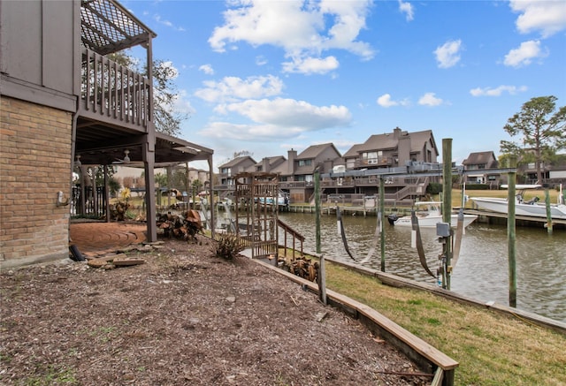 view of yard featuring a water view and a boat dock