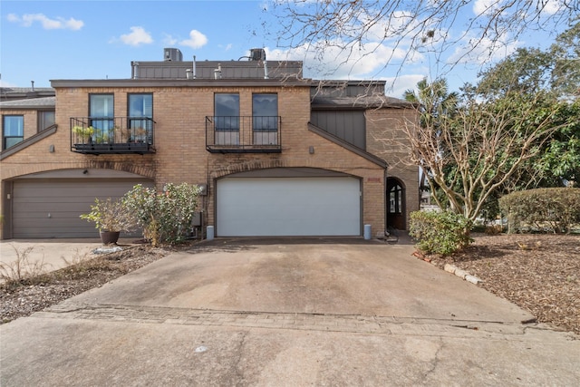 view of front facade with a garage and a balcony