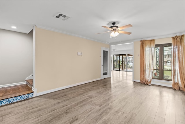 empty room with ornamental molding, ceiling fan, and light wood-type flooring