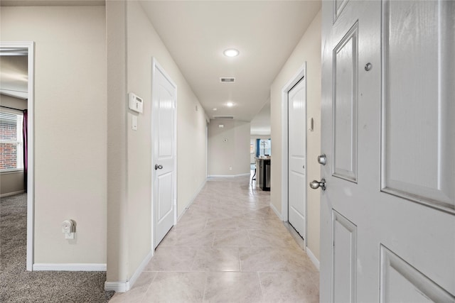 hallway featuring light tile patterned floors