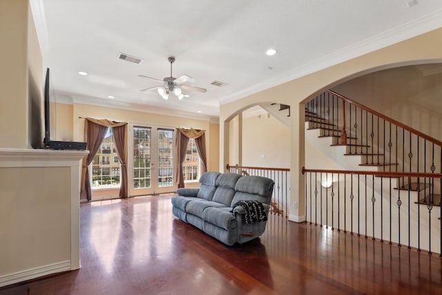 living room with crown molding, ceiling fan, and wood-type flooring