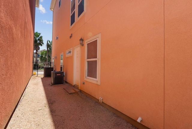 view of side of home with central AC unit