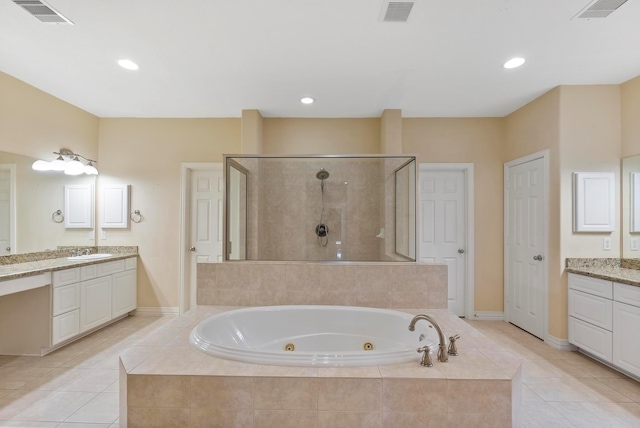 bathroom with independent shower and bath, vanity, and tile patterned floors