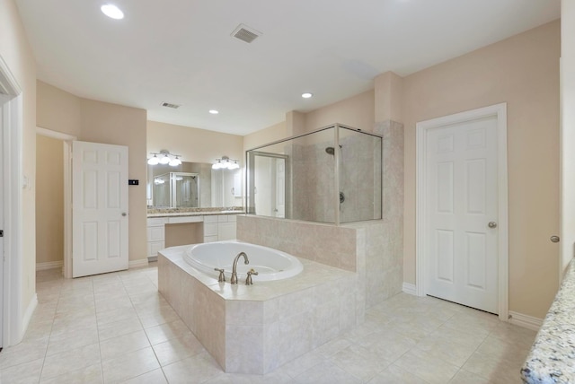 bathroom featuring vanity, shower with separate bathtub, and tile patterned floors