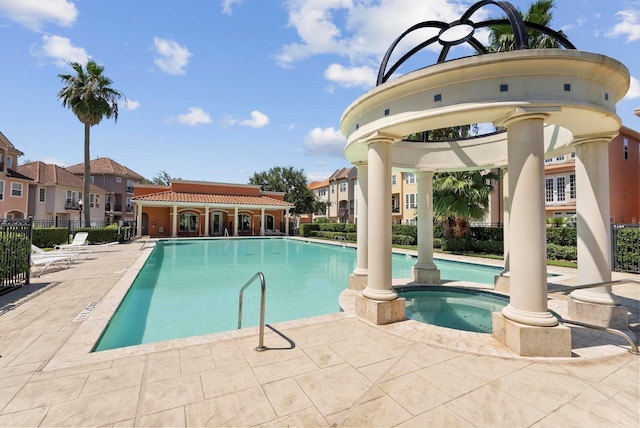 view of pool with a community hot tub and a patio area