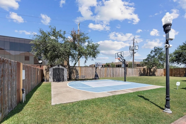 view of basketball court with a yard