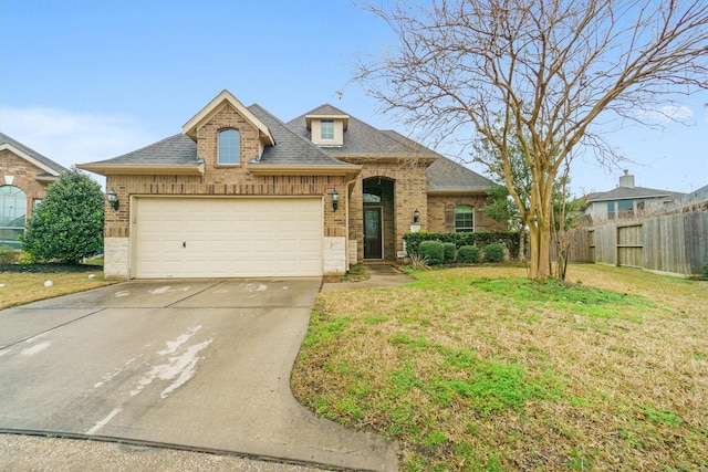 view of front facade featuring a garage and a front lawn