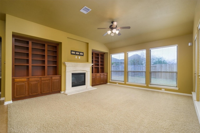 unfurnished living room with carpet floors and ceiling fan