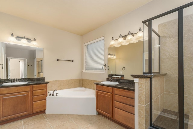 bathroom featuring independent shower and bath, vanity, and tile patterned floors