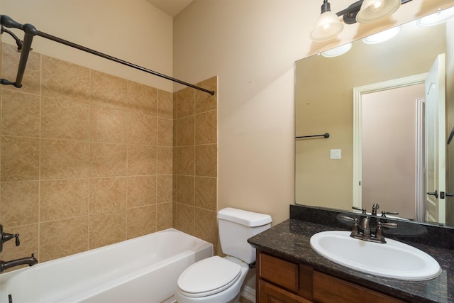 full bathroom with tiled shower / bath combo, vanity, and toilet