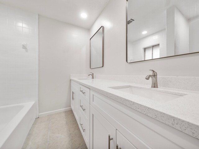 bathroom with tile patterned flooring and vanity