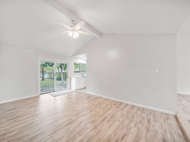 unfurnished room featuring lofted ceiling with beams, ceiling fan, sink, and light hardwood / wood-style floors