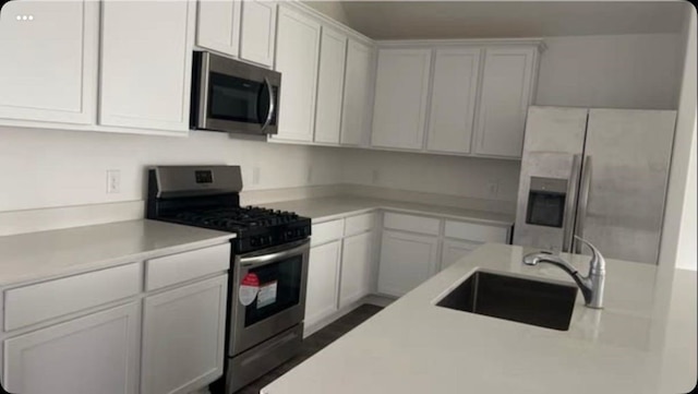 kitchen with white cabinetry, sink, and appliances with stainless steel finishes