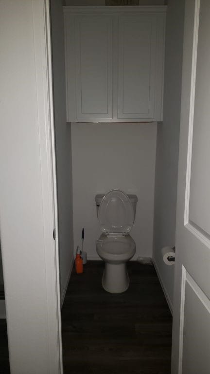 bathroom with hardwood / wood-style floors and toilet