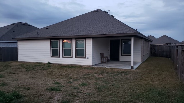 rear view of property with a patio area and a lawn