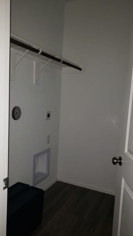 laundry room featuring electric dryer hookup and dark hardwood / wood-style flooring