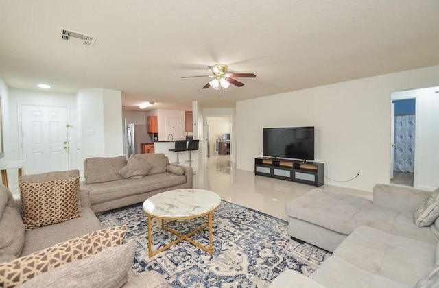 living room with ceiling fan and light tile patterned floors