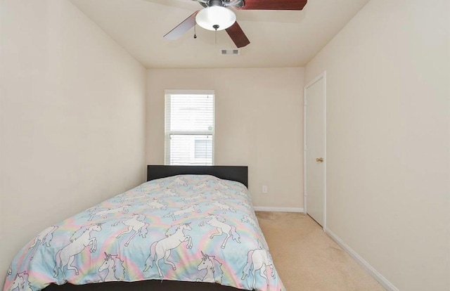 bedroom featuring light carpet and ceiling fan