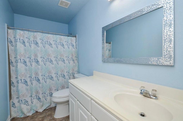 bathroom with vanity, walk in shower, and toilet