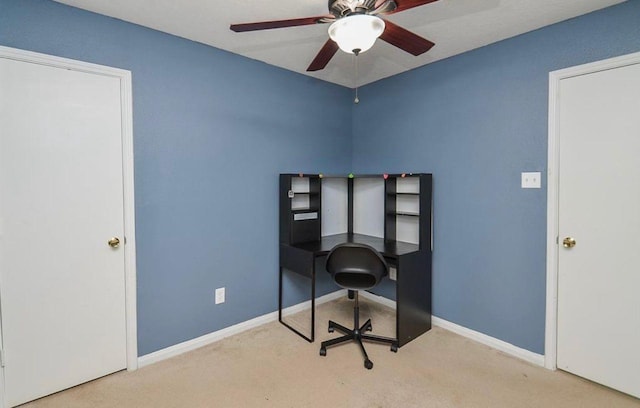 carpeted office space with ceiling fan