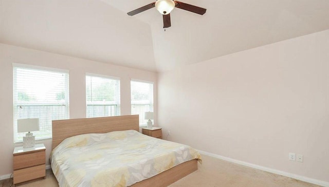 bedroom with lofted ceiling, light carpet, and ceiling fan