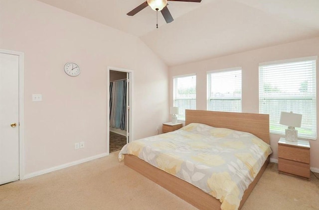 carpeted bedroom with ceiling fan and vaulted ceiling