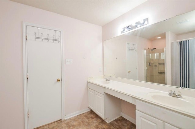 bathroom featuring vanity and tiled shower