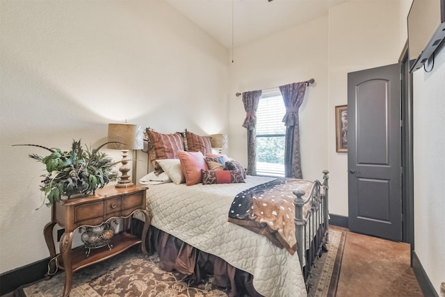 bedroom featuring lofted ceiling and baseboards