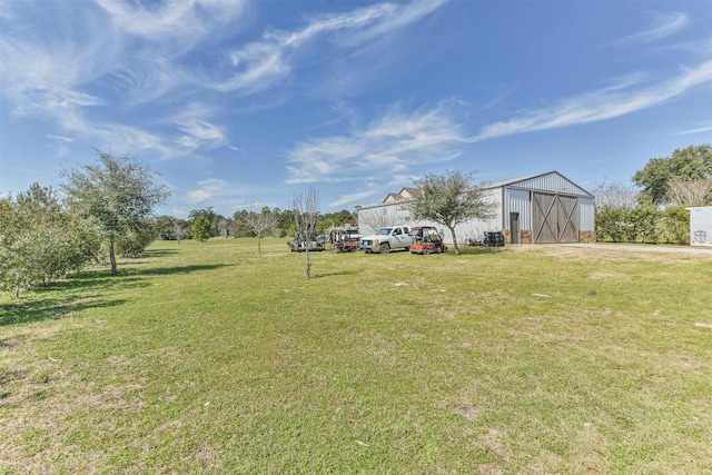 view of yard featuring an outbuilding and a detached garage